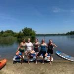 group in front of paddleboards