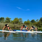 group doing yoga on paddleboards